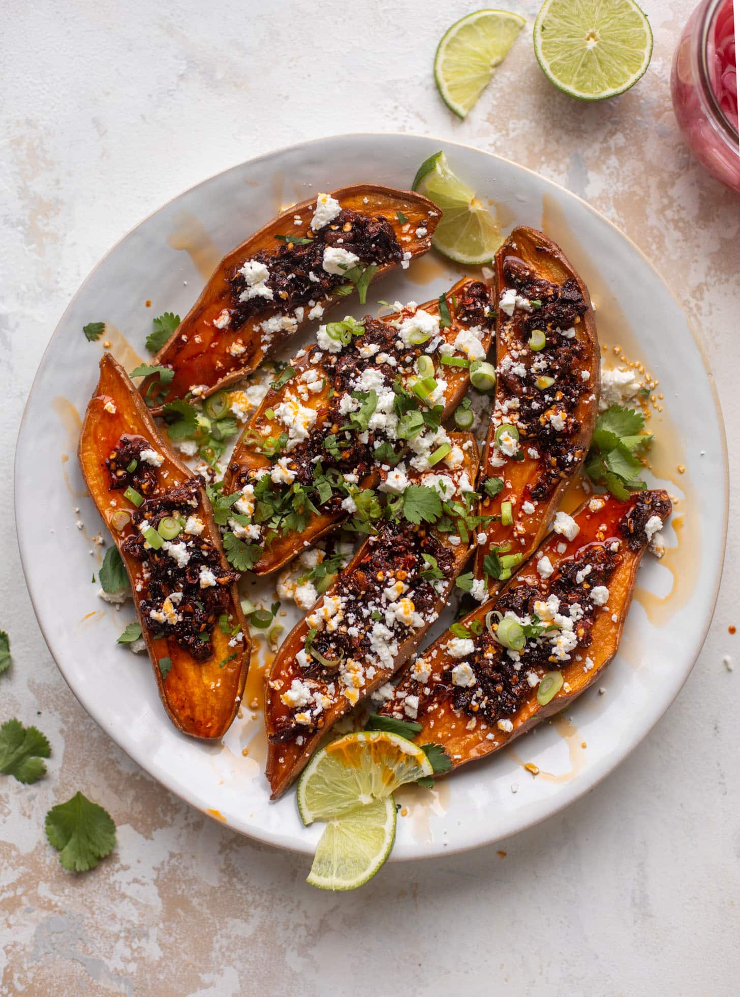 chili crisp sweet potatoes with feta and herbs