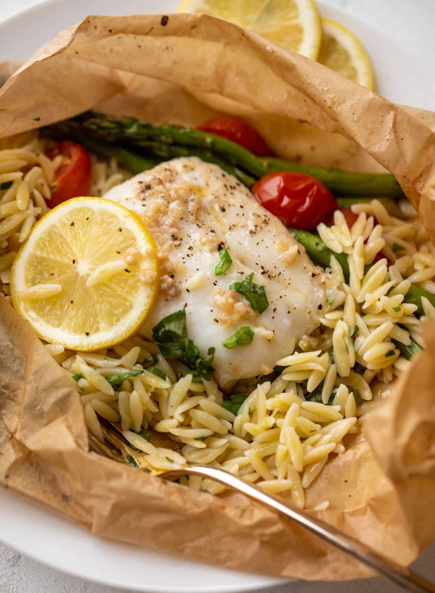 lemon garlic butter orzo and fish in parchment packet