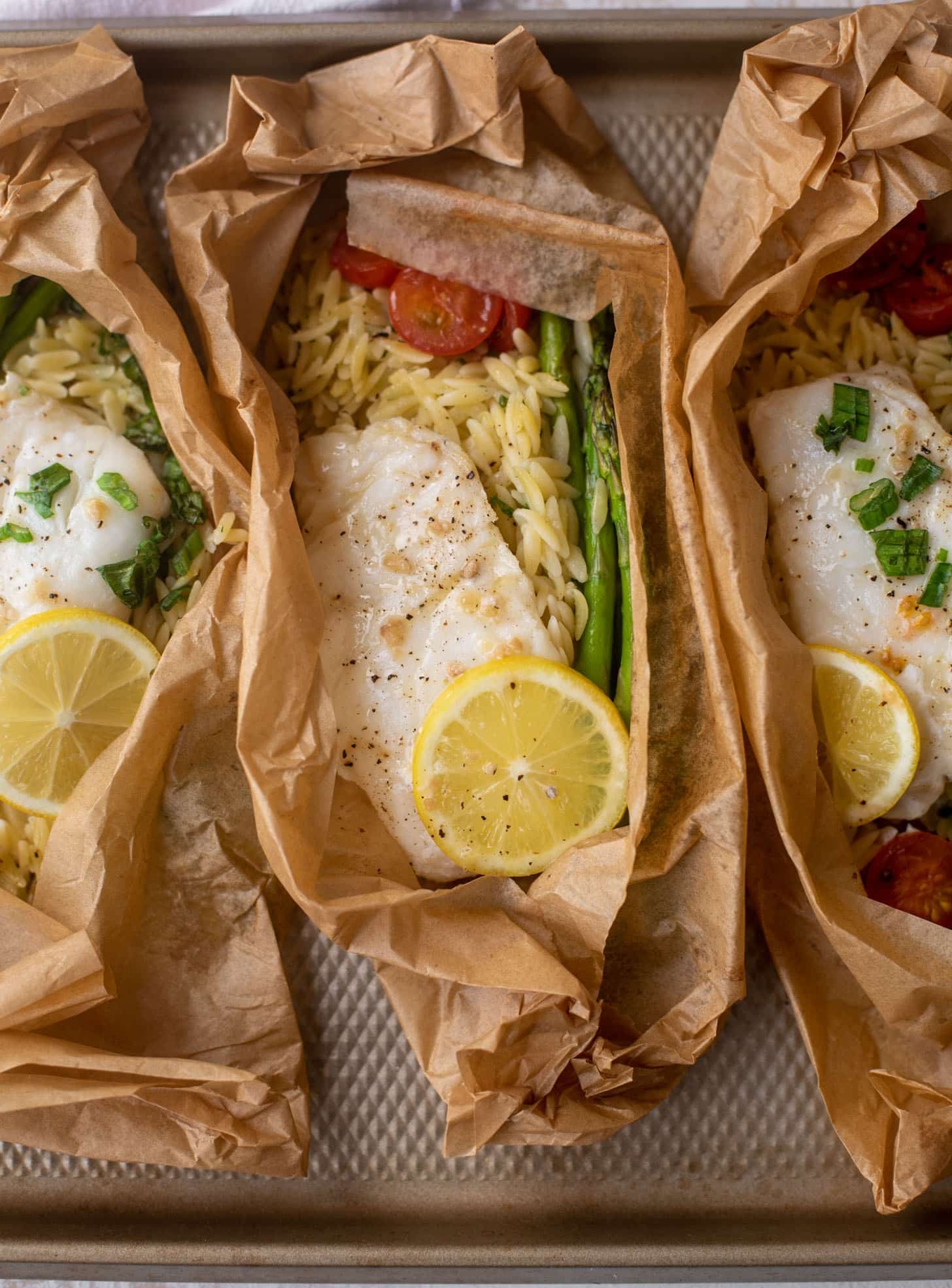 lemon garlic butter orzo and fish in parchment packet