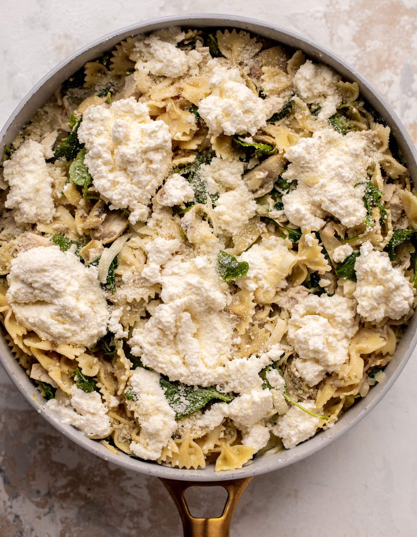 spinach artichoke chicken skillet lasagna ready for the oven