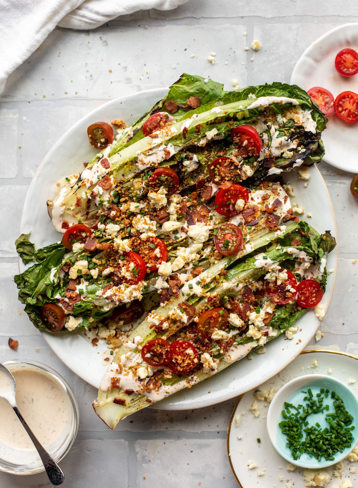 grilled romaine salads with tomatoes, bacon and ranch