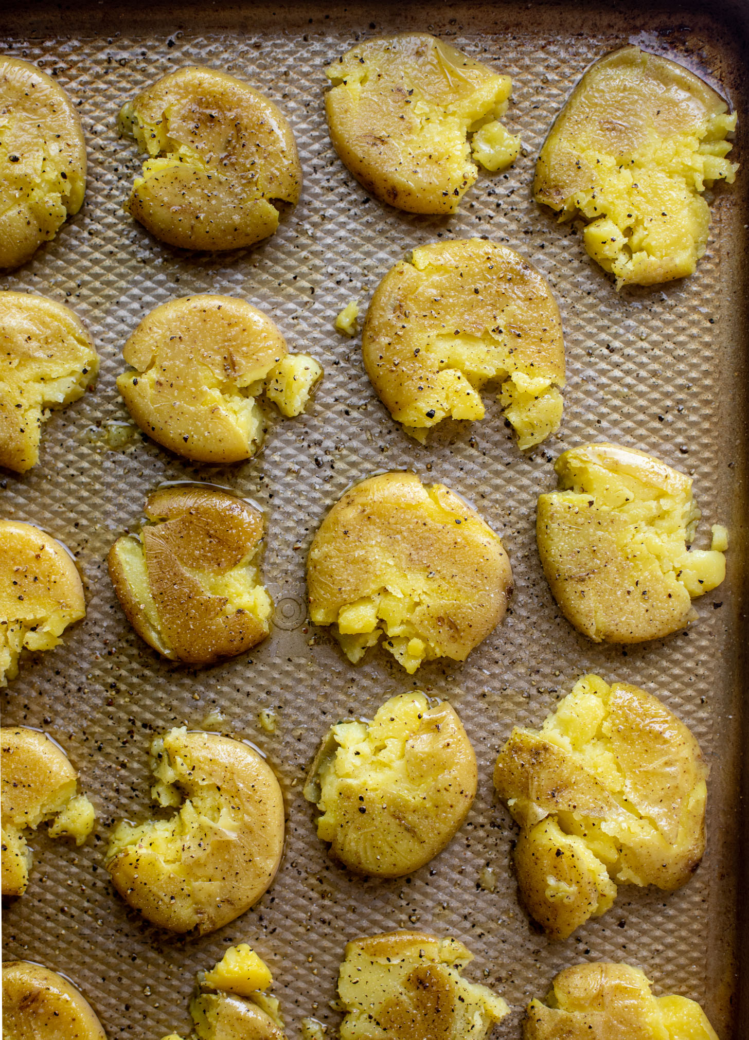 crispy smashed potatoes on a baking sheet