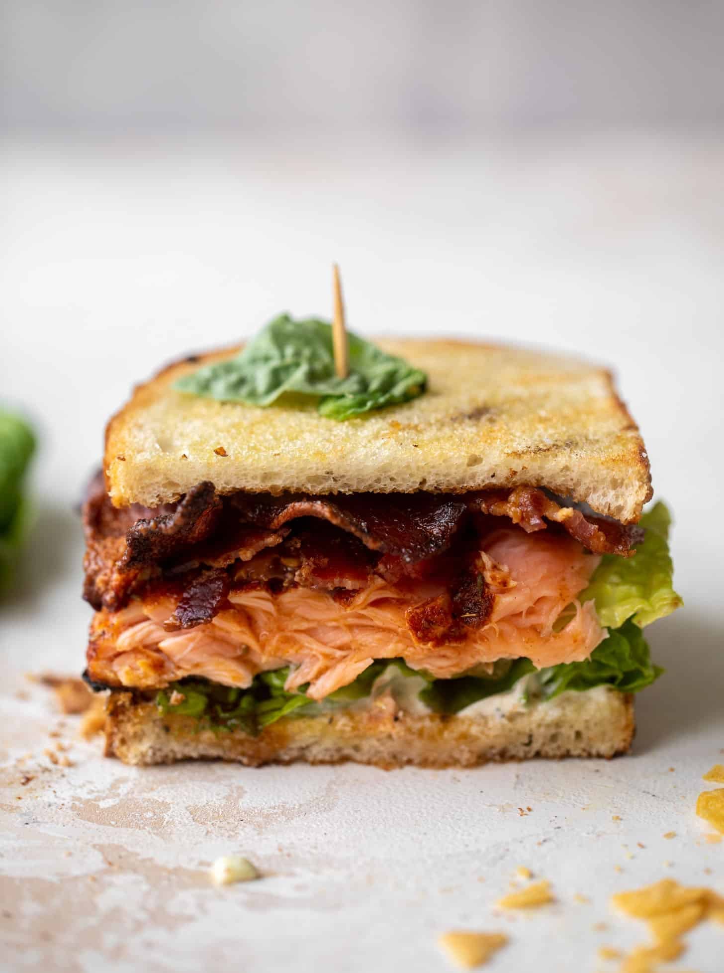salmon club sandwich with charred scallion mayo