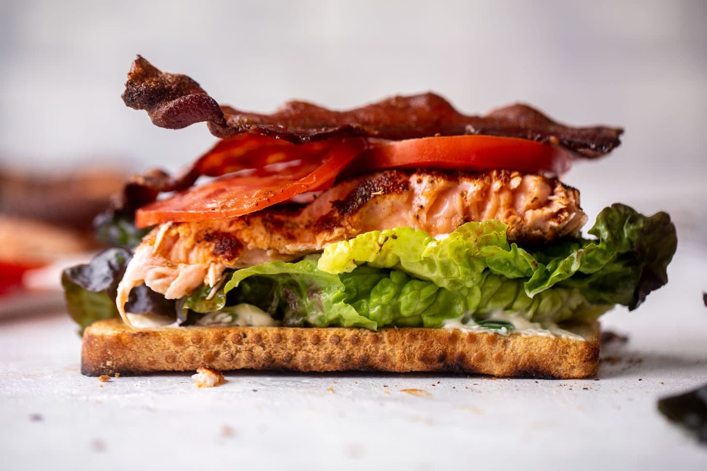salmon club sandwich with charred scallion mayo