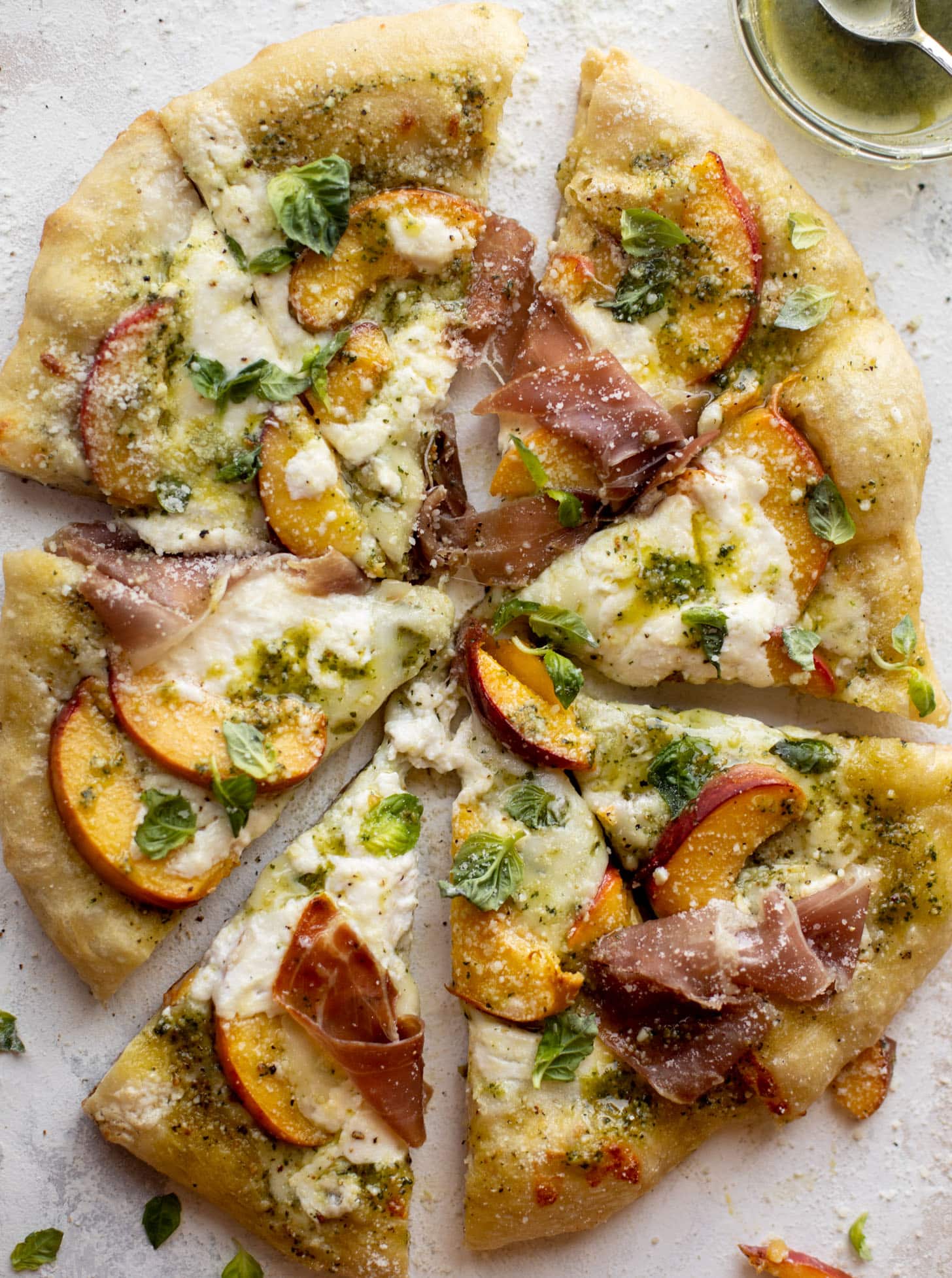 pesto peach pizza with prosciutto and burrata