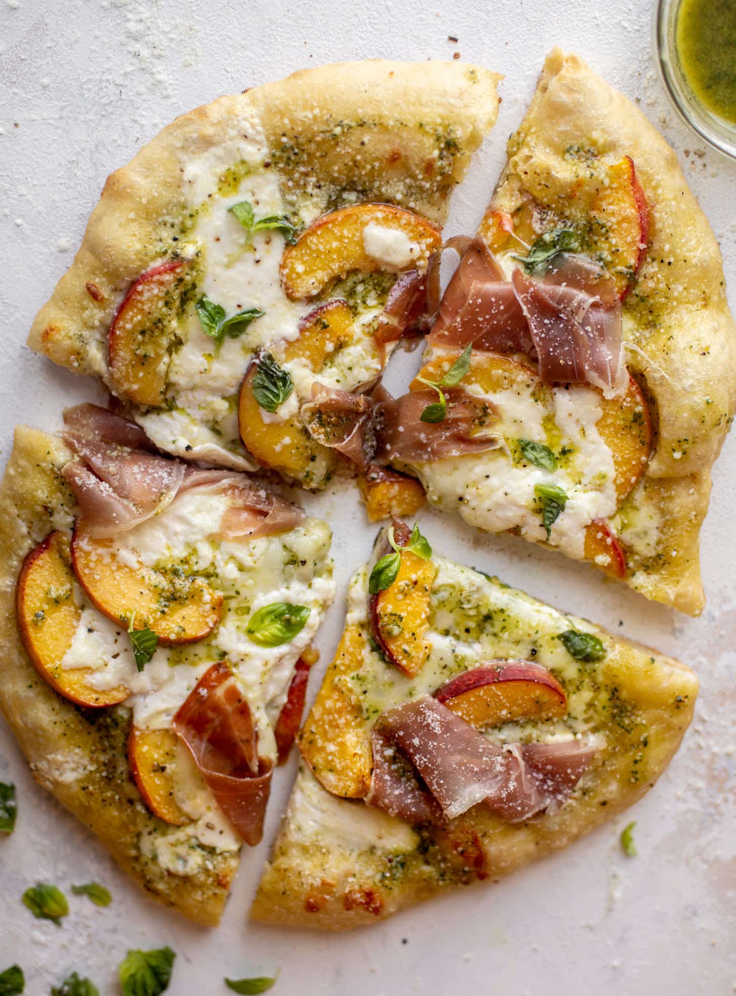 pesto peach pizza with prosciutto and burrata