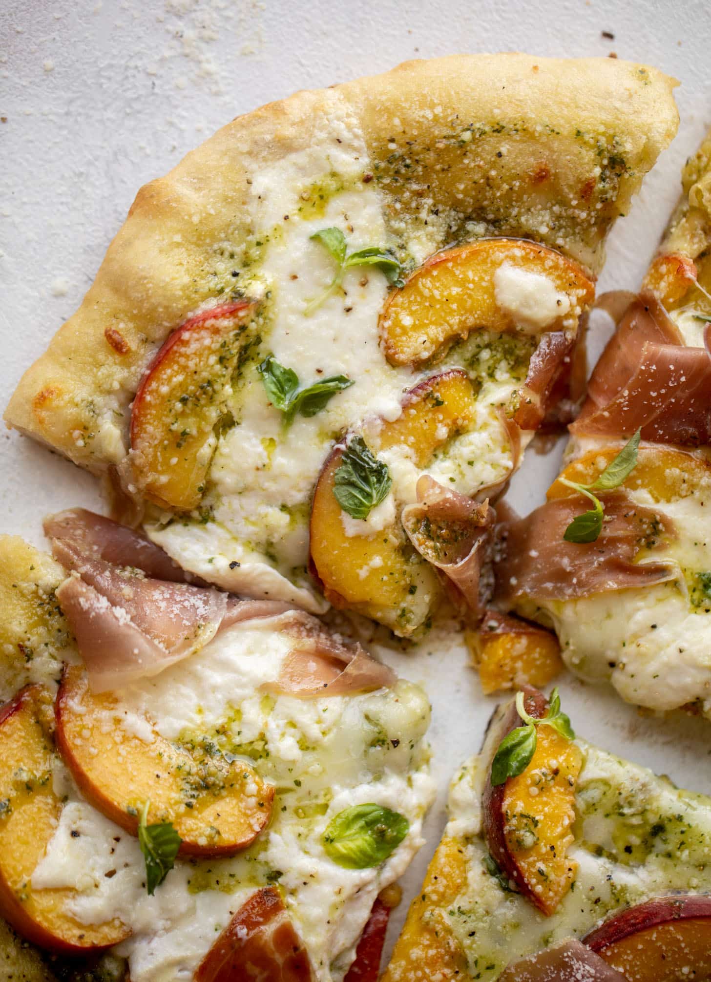 pesto peach pizza with prosciutto and burrata