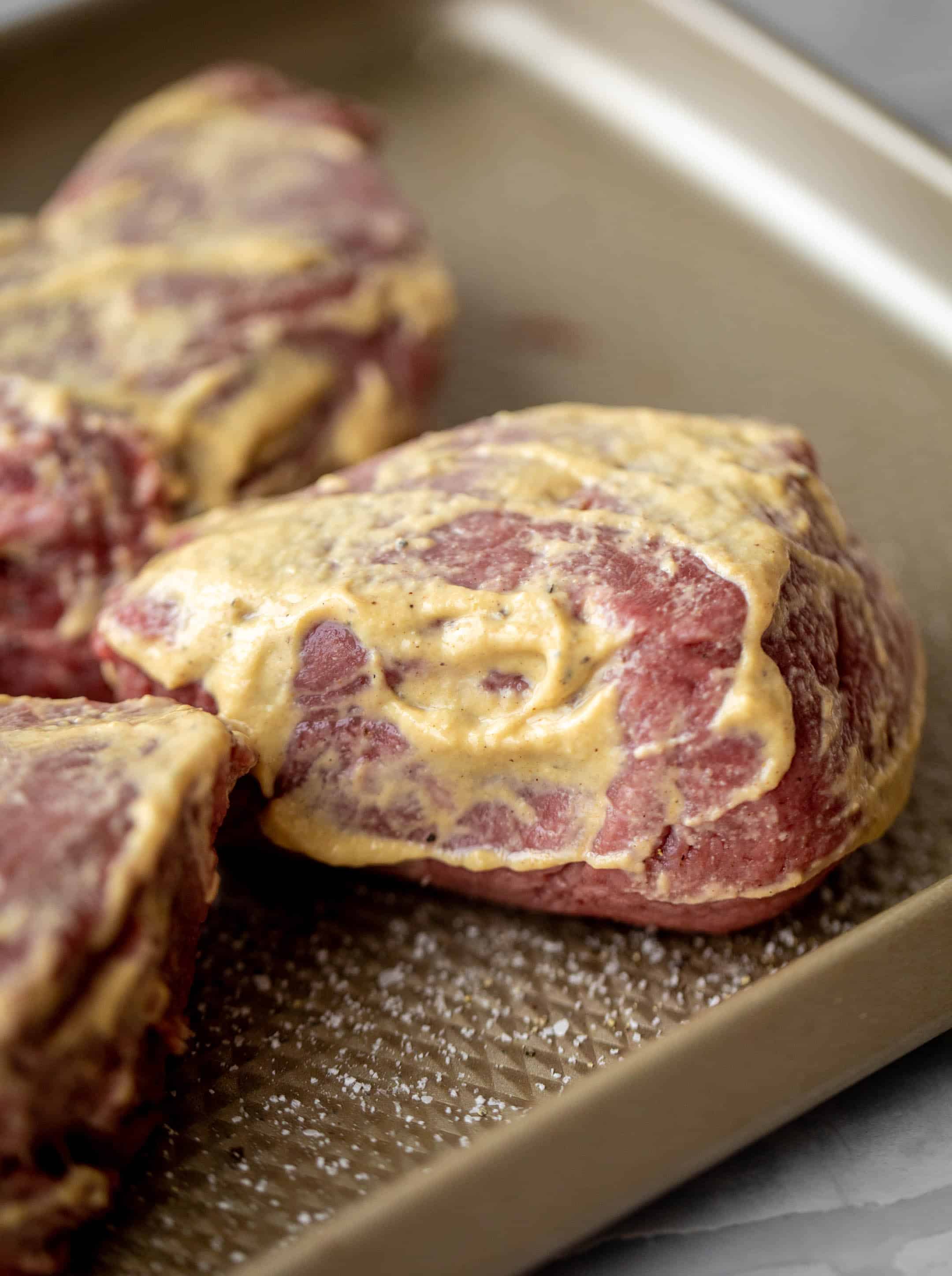 steak rubbed with dijon mustard