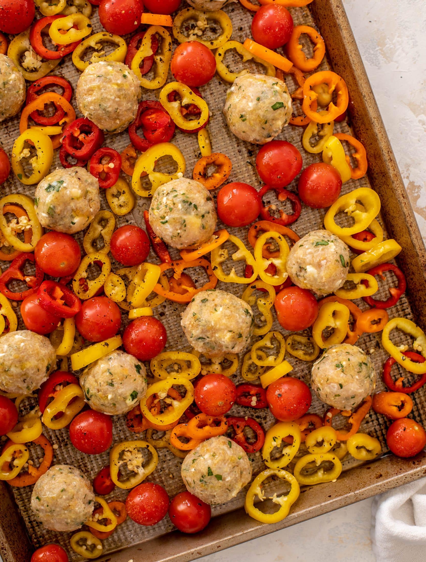 sheet pan chicken meatballs with tomatoes and feta