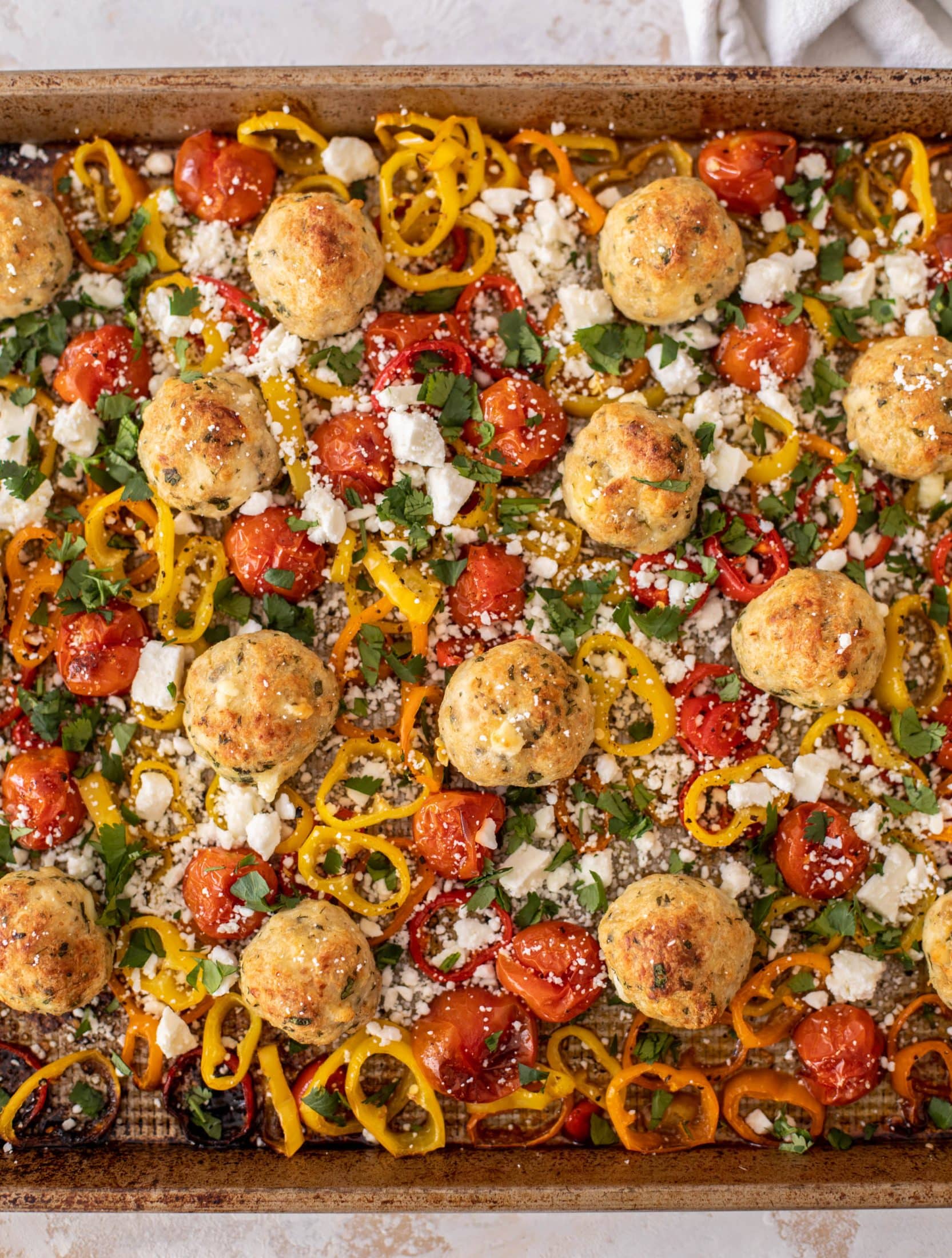 sheet pan chicken meatballs with tomatoes and feta